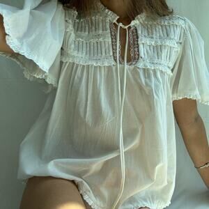White lace babydoll cotton blouse with ruffles and tie front